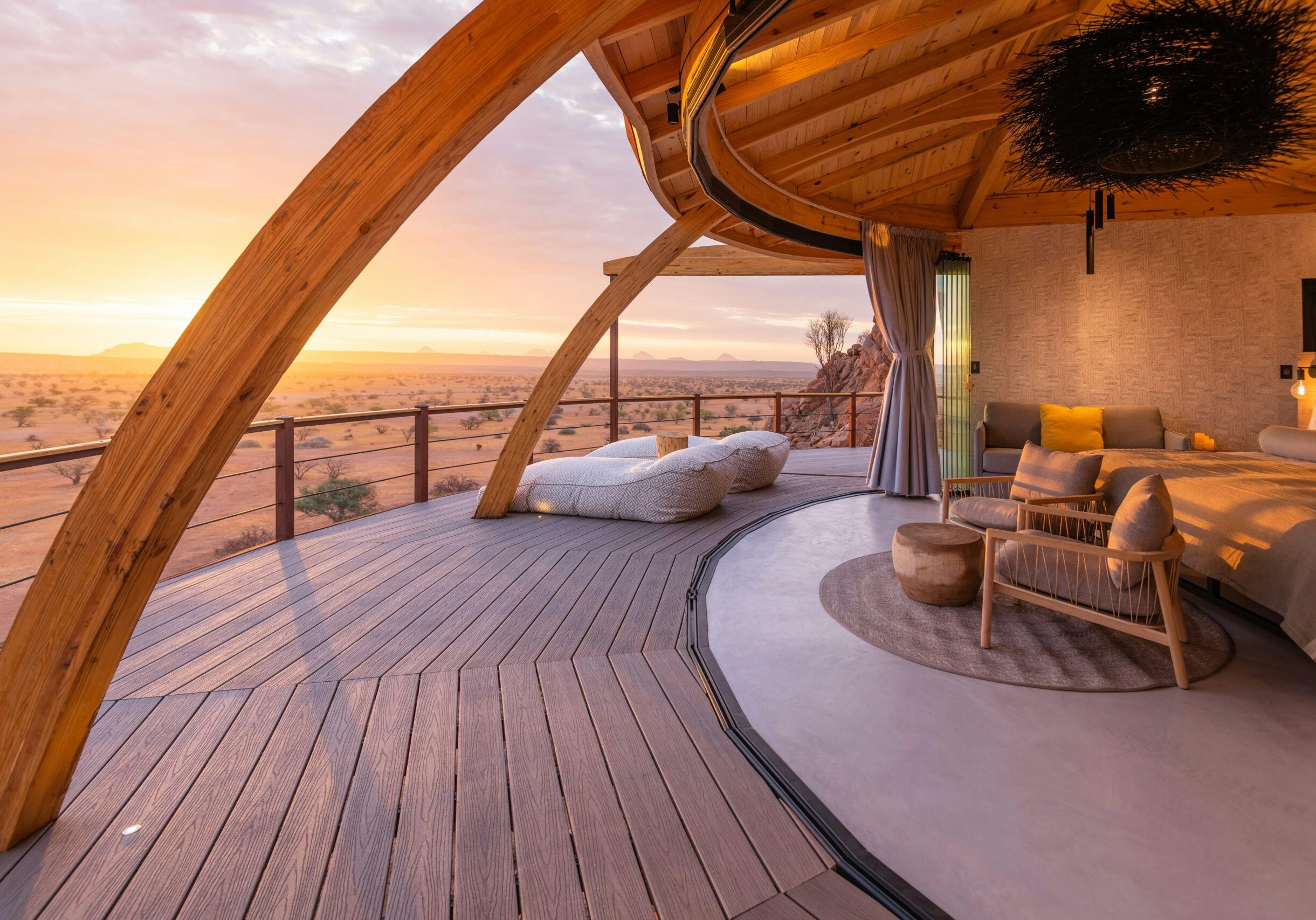 Romantic safari tent with panoramic sunset view in African wilderness.